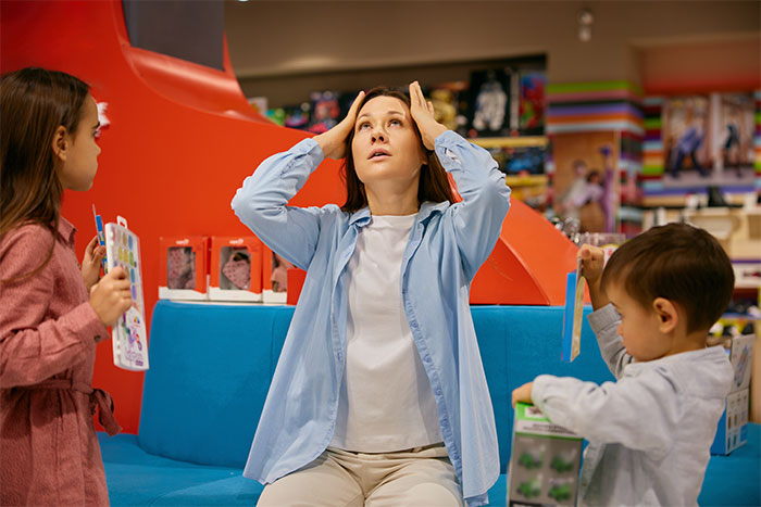 Stressed woman with two kids during a kid outing, highlighting challenges of refusing kid outings with brother’s kids. Stressed woman with two kids during a kid outing, highlighting challenges of refusing kid outings with brother’s kids.