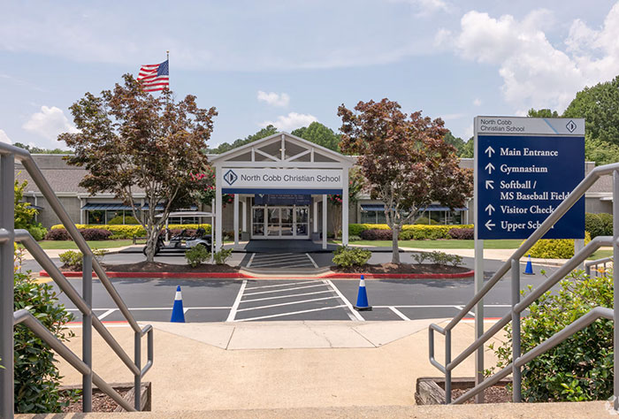 Entrance of North Cobb Christian School with signage visible, related to teen girl expelled over trans prom date debate. Entrance of North Cobb Christian School with signage visible, related to teen girl expelled over trans prom date debate.