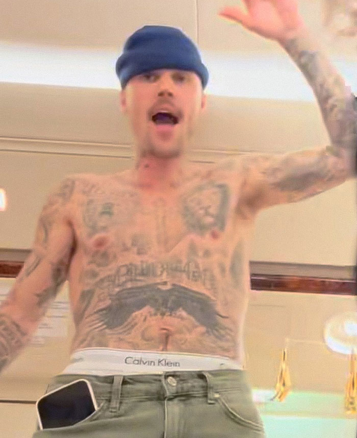 Justin Bieber shirtless in LA, showing tattoos and wearing a beanie while expressing emotion during casual moment indoors. Justin Bieber shirtless in LA, showing tattoos and wearing a beanie while expressing emotion during casual moment indoors.
