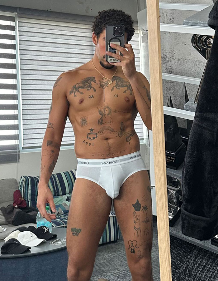 Bad Bunny shirtless selfie in white Calvin Klein underwear, showing tattoos and posing in a bedroom mirror. Bad Bunny shirtless selfie in white Calvin Klein underwear, showing tattoos and posing in a bedroom mirror.