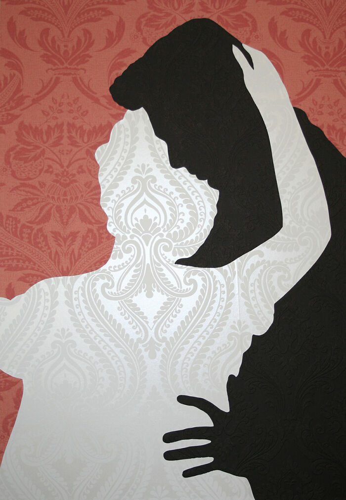 Silhouettes of a couple embracing with intricate wallpaper patterns in a creative photo manipulation collage.