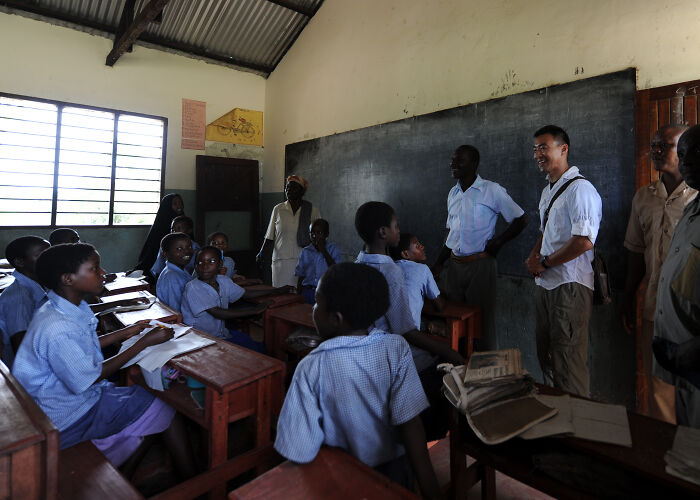 Classroom with students and teachers engaged in a discussion highlighting national stereotypes in an educational setting.