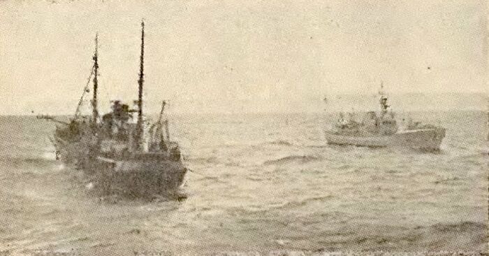 Two old ships on rough sea waves illustrating bizarre historical events at sea in vintage style photograph.