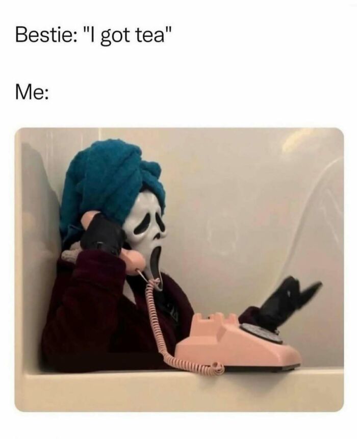 Person wearing a ghost mask and towel on head, holding a phone while sitting in a bathtub relatable memes humor concept.