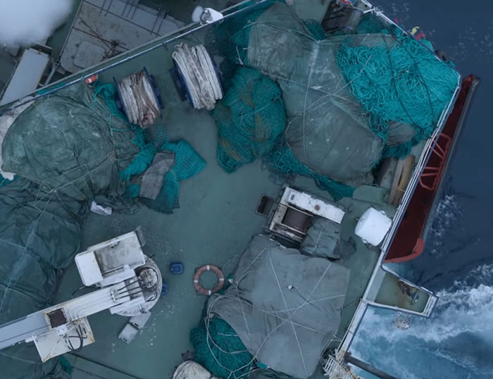 Fishing nets and equipment on a boat deck, highlighting environmental concerns from David Attenborough's urgent warning. Fishing nets and equipment on a boat deck, highlighting environmental concerns from David Attenborough's urgent warning.