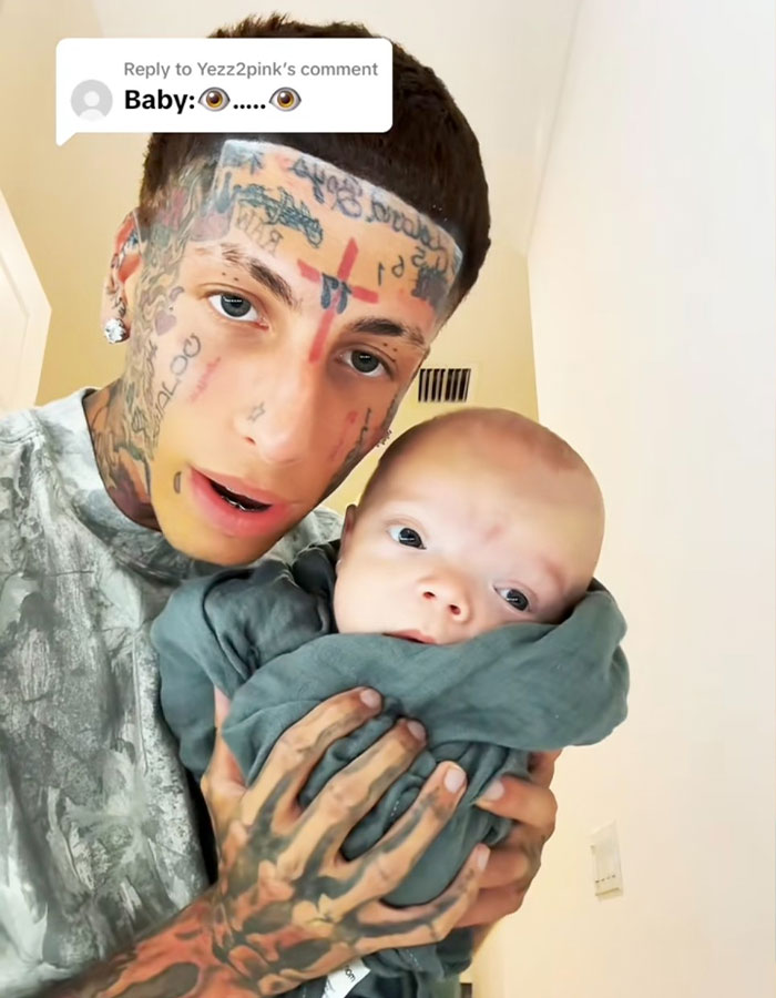 Island Boy holding his baby, responding to fans bullying his baby in a series of emotional videos. Island Boy holding his baby, responding to fans bullying his baby in a series of emotional videos.
