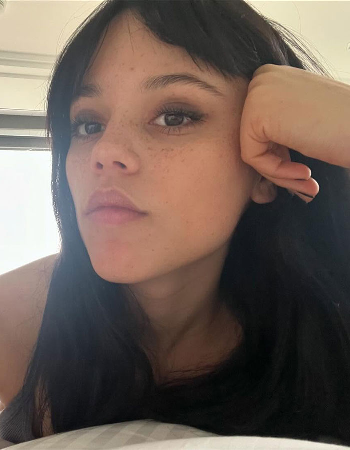 Jenna Ortega close-up selfie showing natural makeup and dark hair, reflecting on tension and fear in a candid moment. Jenna Ortega close-up selfie showing natural makeup and dark hair, reflecting on tension and fear in a candid moment.