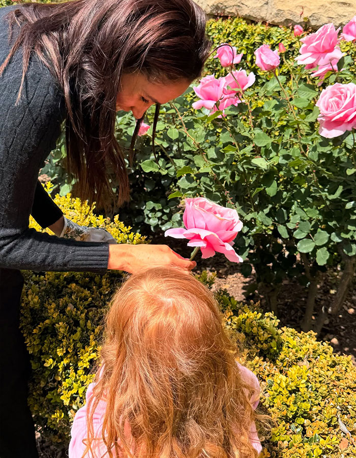 Meghan Markle shares a Mother’s Day moment with children Lilibet and Archie among pink roses in a garden setting. Meghan Markle shares a Mother’s Day moment with children Lilibet and Archie among pink roses in a garden setting.