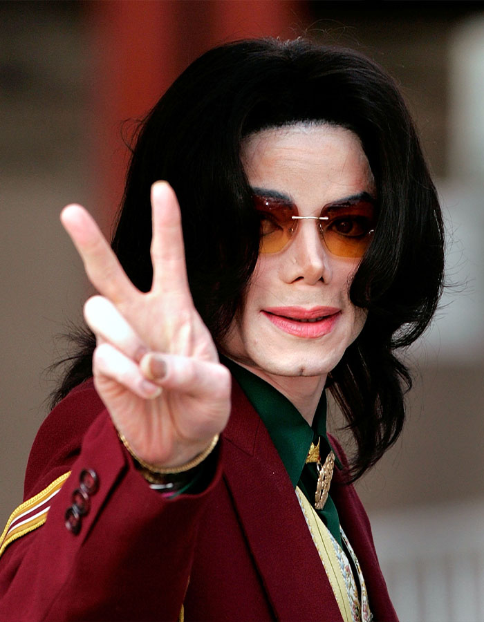 Michael Jackson wearing sunglasses and a red jacket, making a peace sign with his hand, sparking iconic lean doubts. Michael Jackson wearing sunglasses and a red jacket, making a peace sign with his hand, sparking iconic lean doubts.