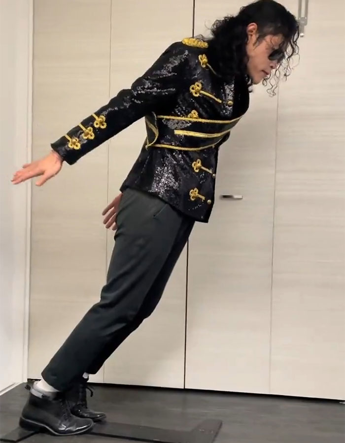 Person dressed as Michael Jackson performing the iconic lean pose, sparking new doubts about the move years after his passing. Person dressed as Michael Jackson performing the iconic lean pose, sparking new doubts about the move years after his passing.