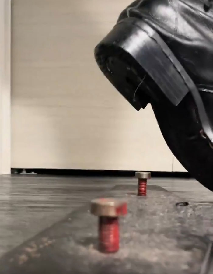 Close-up of black leather shoe and bolts highlighting Michael Jackson's iconic lean and related doubts years after his passing. Close-up of black leather shoe and bolts highlighting Michael Jackson's iconic lean and related doubts years after his passing.