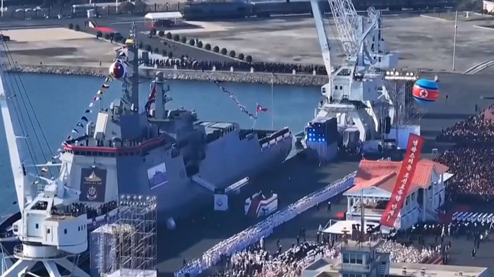 North Korean 5,000-ton warship capsizing during a naval event with crowds and military personnel present. North Korean 5,000-ton warship capsizing during a naval event with crowds and military personnel present.
