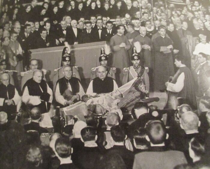 Historic black and white photo showing a gathering of clergy and officials during a significant pope-related event.