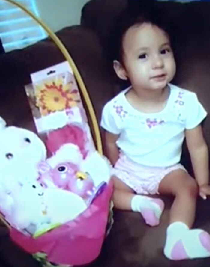 7-year-old girl sitting on couch next to a basket of toys during search for missing sister continues. 7-year-old girl sitting on couch next to a basket of toys during search for missing sister continues.