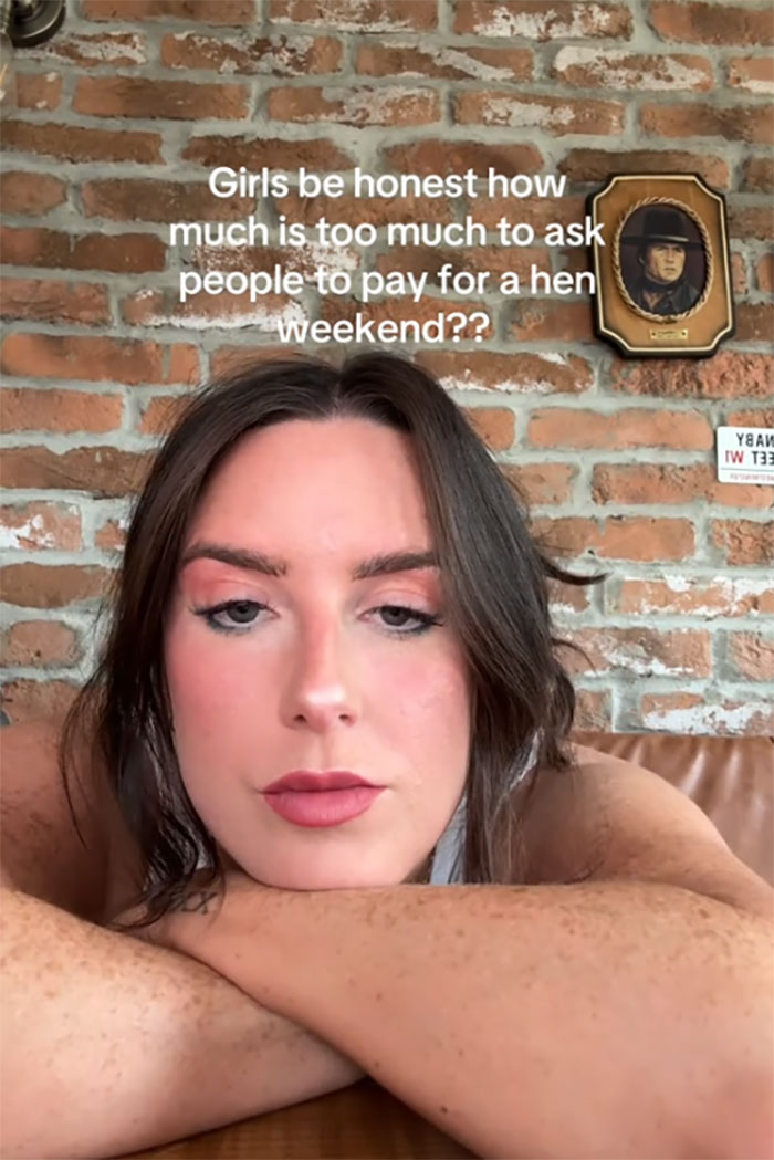 Young woman resting on her arms with text asking how much is too much to pay for hen parties on brick wall background. Young woman resting on her arms with text asking how much is too much to pay for hen parties on brick wall background.