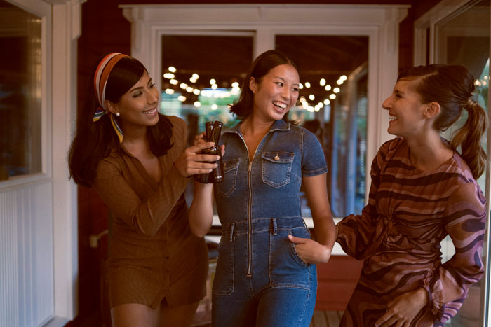 Three women smiling and chatting on a porch highlighting sister promises to return and leaving 18YO with kids for days Three women smiling and chatting on a porch highlighting sister promises to return and leaving 18YO with kids for days