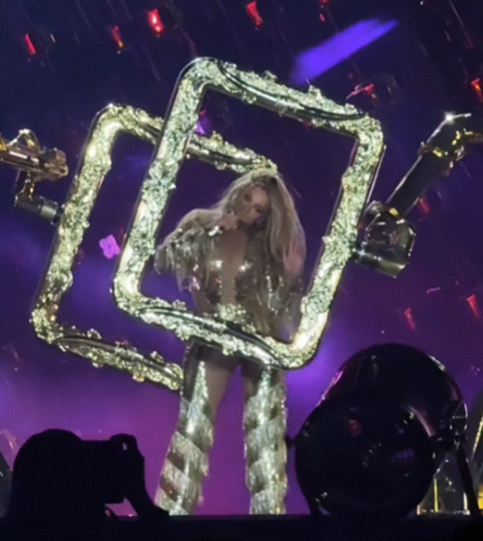 Beyoncé performing on stage with glowing frames during a concert, fan safety concerns over dangerous malfunction. Beyoncé performing on stage with glowing frames during a concert, fan safety concerns over dangerous malfunction.