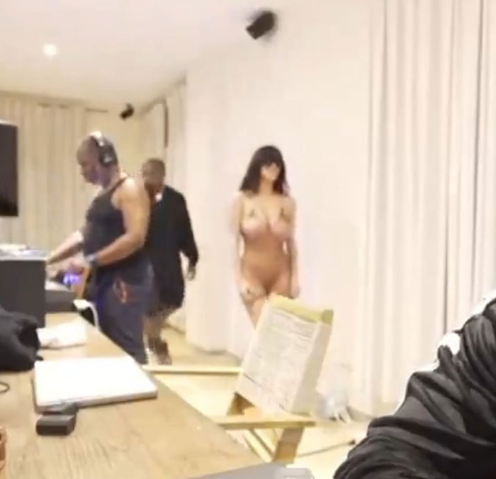 Kanye West's friend covering camera quickly while Bianca Censori struts in wearing minimal clothing indoors. Kanye West's friend covering camera quickly while Bianca Censori struts in wearing minimal clothing indoors.