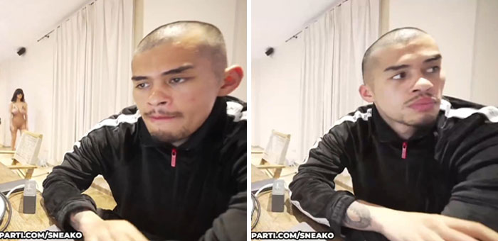 Kanye West's friend quickly covers camera as Bianca Censori walks in wearing minimal clothing in a casual room setting. Kanye West's friend quickly covers camera as Bianca Censori walks in wearing minimal clothing in a casual room setting.