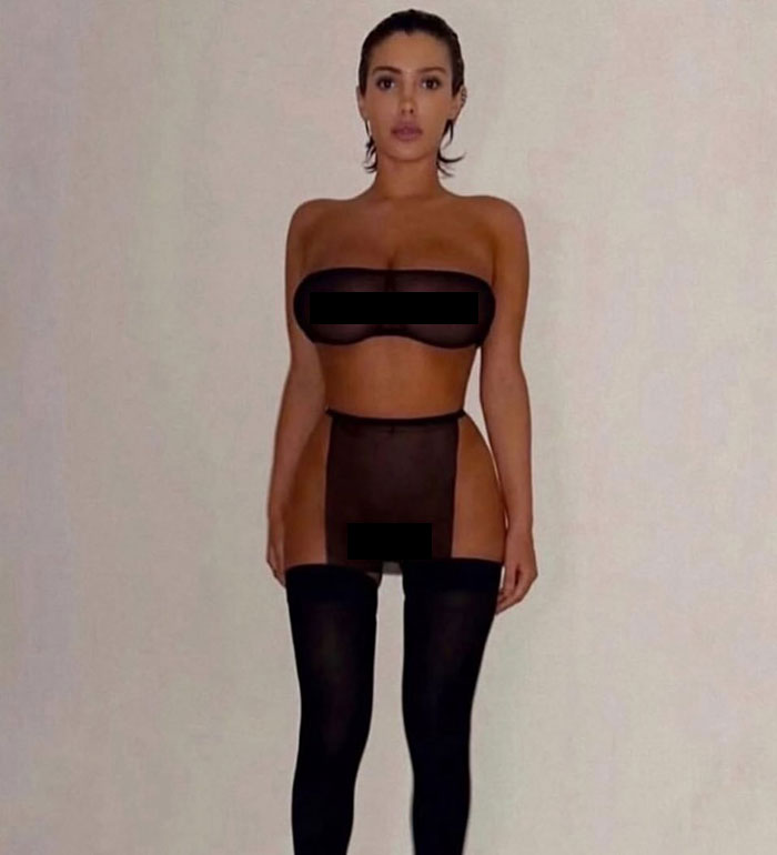 Bianca Censori posing confidently in sheer black lingerie with thigh-high stockings against a plain background. Bianca Censori posing confidently in sheer black lingerie with thigh-high stockings against a plain background.