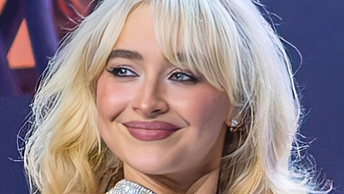 Blonde woman smiling with makeup and sparkly outfit, illustrating stranger ways people cross paths with celebs.
