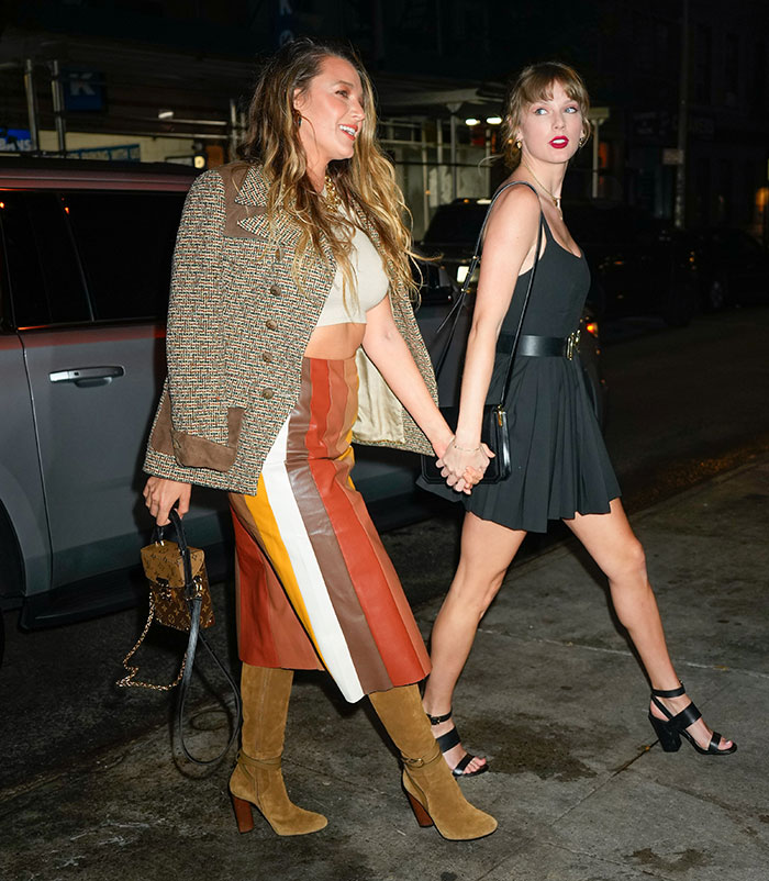 Blake Lively and Taylor Swift holding hands walking at night, linked in alleged blackmail feud with personal texts. Blake Lively and Taylor Swift holding hands walking at night, linked in alleged blackmail feud with personal texts.