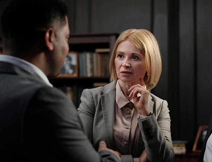 Boss and employee in a serious office discussion, highlighting workplace bullying and playing it by the book negotiation. Boss and employee in a serious office discussion, highlighting workplace bullying and playing it by the book negotiation.