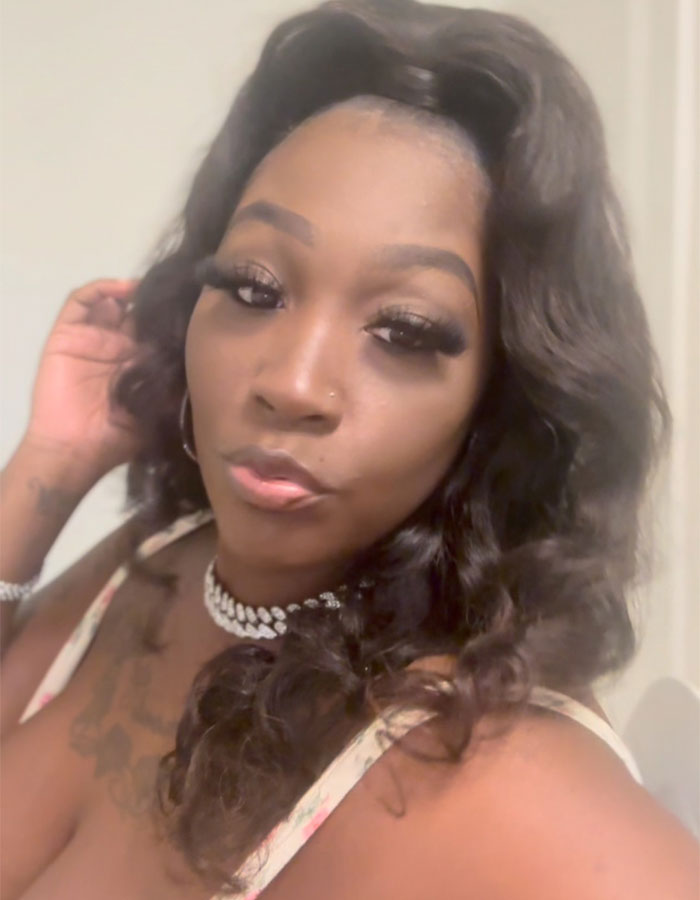 Close-up of a woman with long curly hair and makeup, representing a mom involved in public breastfeeding controversy. Close-up of a woman with long curly hair and makeup, representing a mom involved in public breastfeeding controversy.