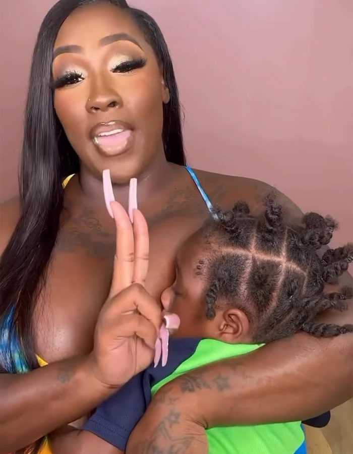 Woman breastfeeding her child, addressing netizens, highlighting the controversy of publicly breastfeeding at a restaurant. Woman breastfeeding her child, addressing netizens, highlighting the controversy of publicly breastfeeding at a restaurant.