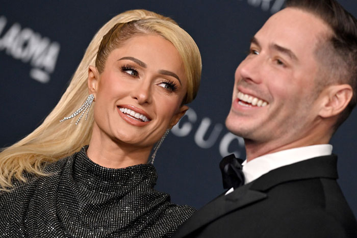 Paris Hilton and Carter Reum in formal attire smiling at an event, highlighting Carter Reum’s fortune and M13 Ventures growth.