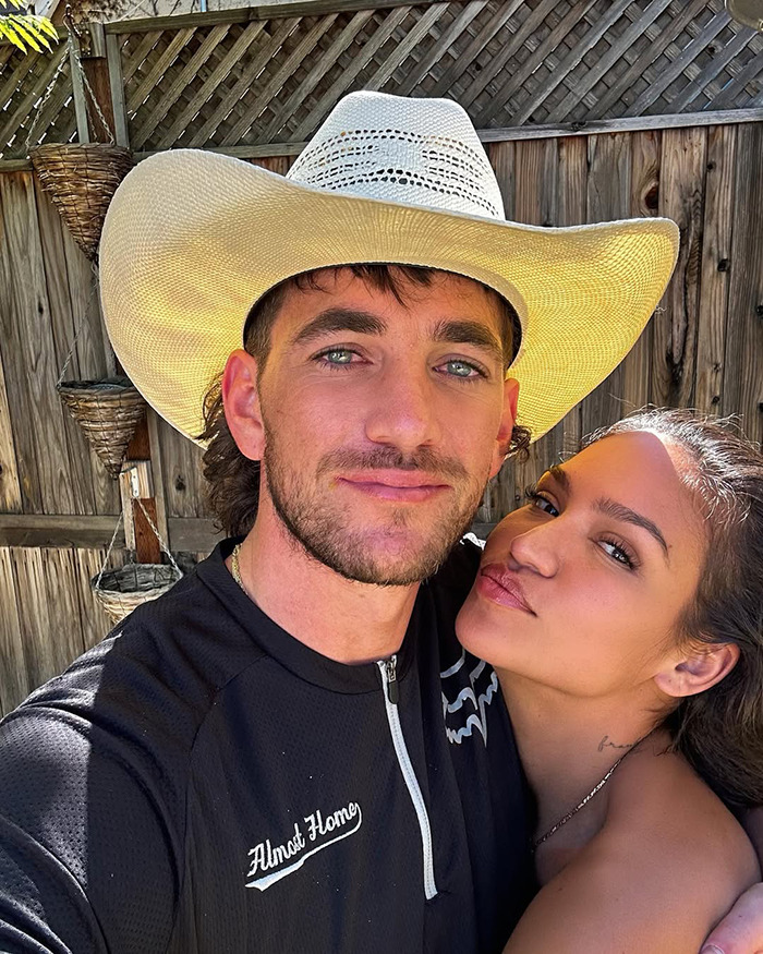 Cassie Ventura's husband wearing a cowboy hat, posing closely with Cassie Ventura outdoors by wooden fencing. Cassie Ventura's husband wearing a cowboy hat, posing closely with Cassie Ventura outdoors by wooden fencing.