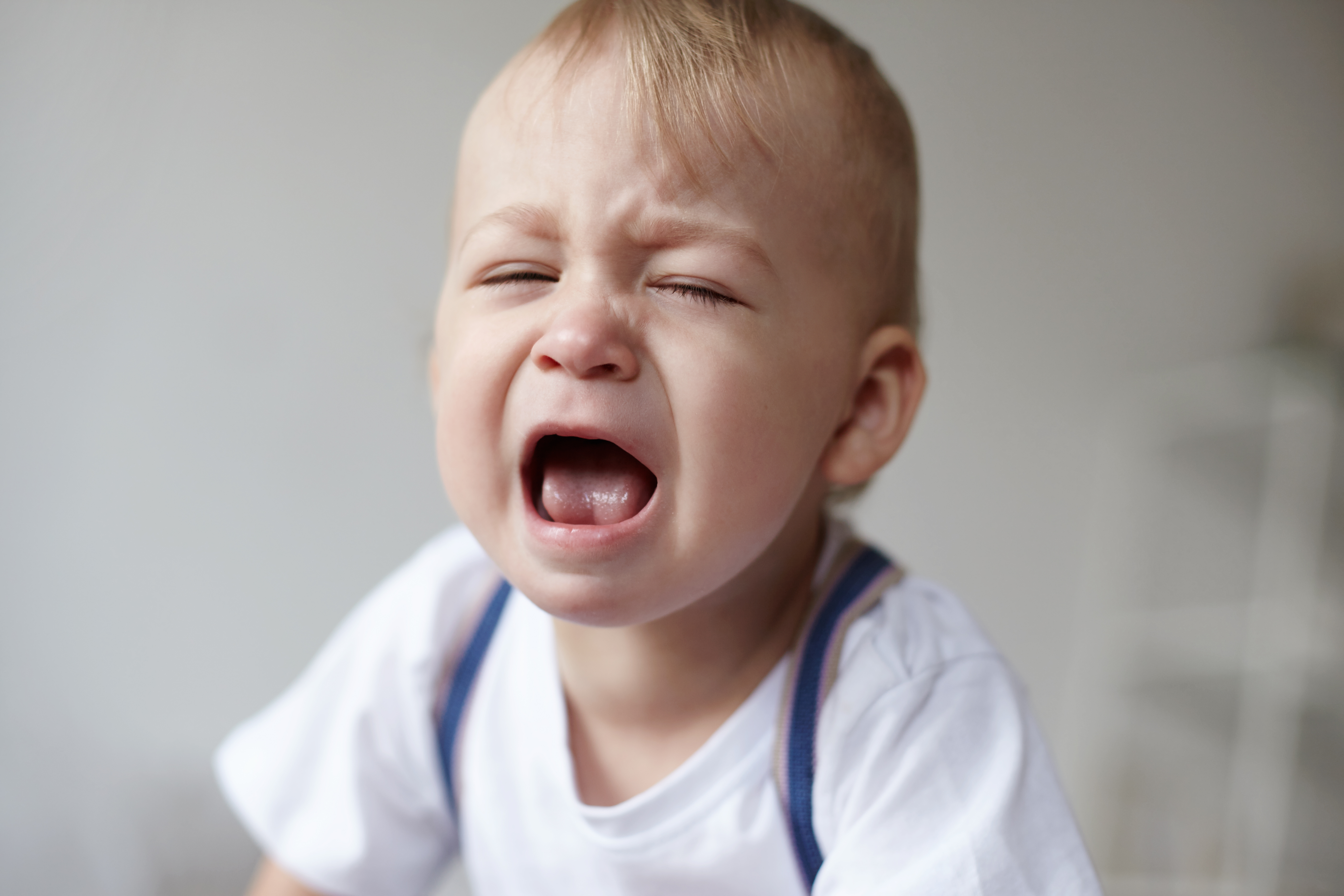 Toddler crying and destroying cake while a guy moves the cake away, getting side-eye from parents nearby. Toddler crying and destroying cake while a guy moves the cake away, getting side-eye from parents nearby.