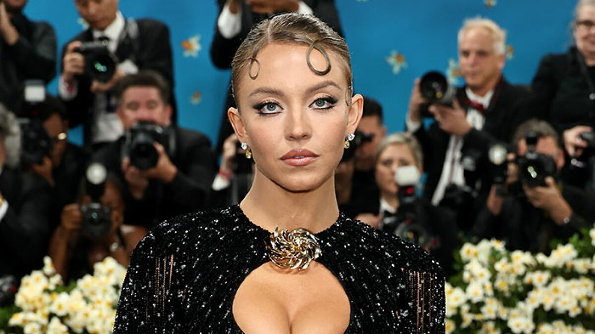 Sydney Sweeney on Met Gala red carpet with photographers in background, fashion and puppy controversy trending online.