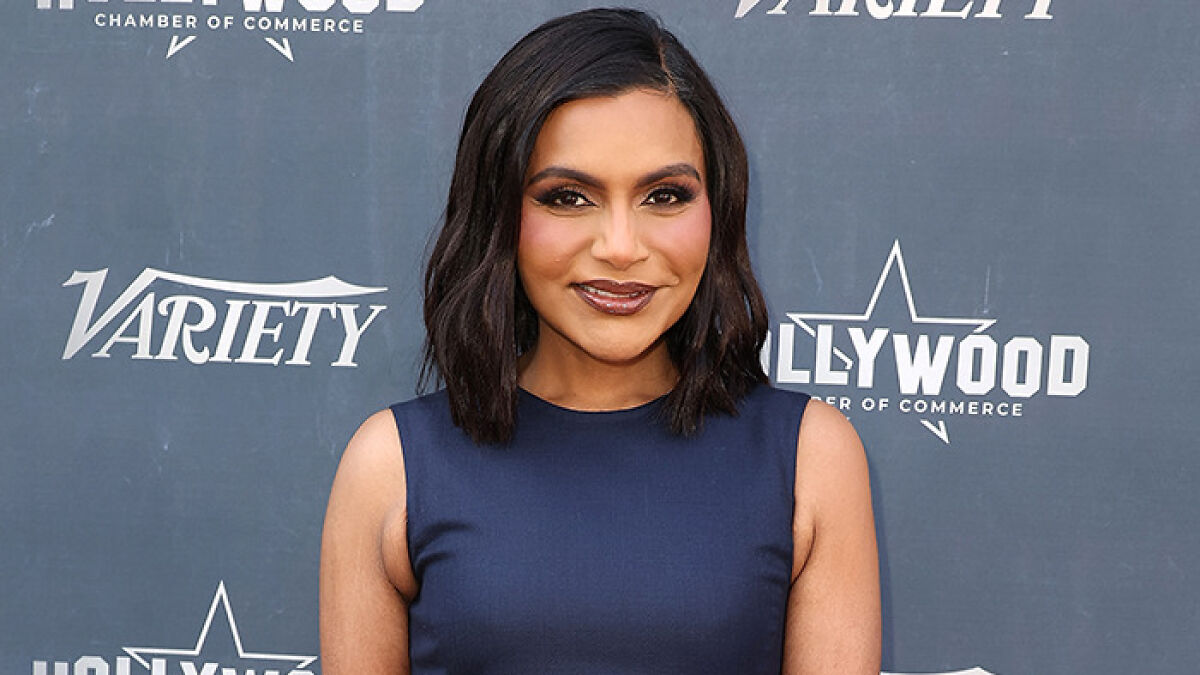 Mindy Kaling showing off slim figure at a Hollywood event amid Ozempic rumors, wearing a sleeveless navy dress.