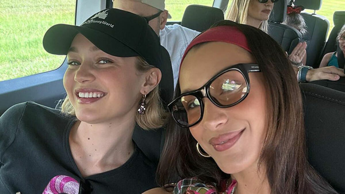Gigi and Bella Hadid smiling together in a car, revealing secret sister from their father's fling over 20 years ago.