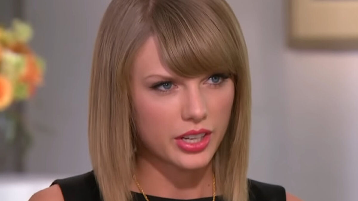 Taylor Swift in a close-up interview setting, engaging in a serious and intense conversation on camera.