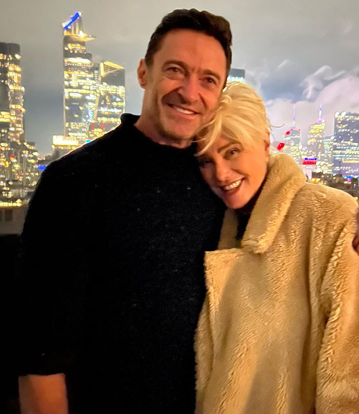 Hugh Jackman and Deborra-Lee Furness smiling together outdoors with city lights in the background at night. Hugh Jackman and Deborra-Lee Furness smiling together outdoors with city lights in the background at night.