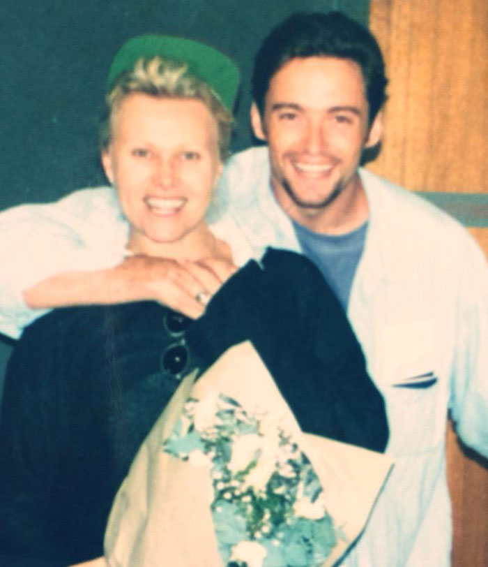 Deborra-Lee Furness and Hugh Jackman smiling together, holding flowers during a candid moment in their journey of betrayal. Deborra-Lee Furness and Hugh Jackman smiling together, holding flowers during a candid moment in their journey of betrayal.