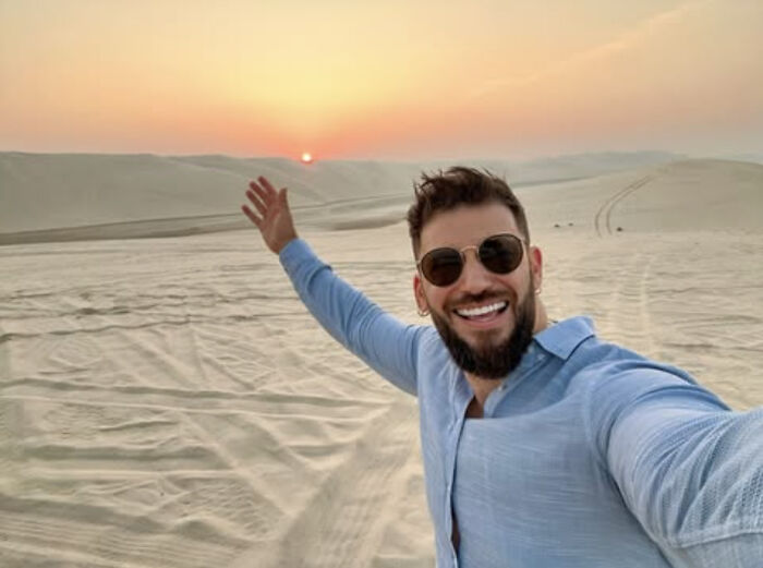 Actor who played Viktor Krum from Harry Potter smiling and taking a selfie in a desert during sunset. Actor who played Viktor Krum from Harry Potter smiling and taking a selfie in a desert during sunset.