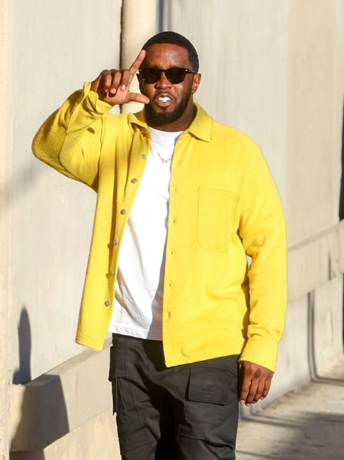 Diddy wearing sunglasses and a yellow jacket outdoors, highlighting Diddy’s net worth and legal trouble impact.