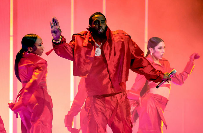 Diddy performing on stage with dancers, highlighting concerns about Diddy’s net worth amid legal trouble and challenges.