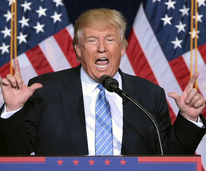 Donald Trump speaking at a podium with American flags behind, reacting to comments on Taylor Swift and White House response. Donald Trump speaking at a podium with American flags behind, reacting to comments on Taylor Swift and White House response.