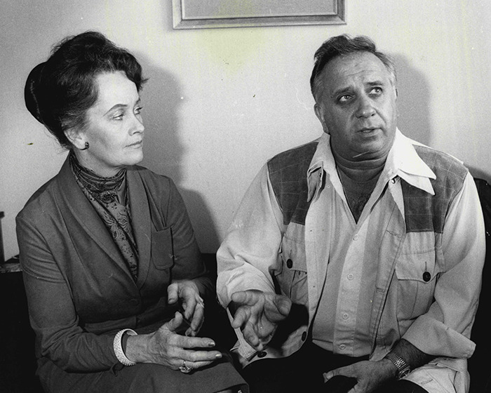 Two people in a serious discussion, reflecting on the haunted Annabelle doll's chilling history resurfacing. Two people in a serious discussion, reflecting on the haunted Annabelle doll's chilling history resurfacing.