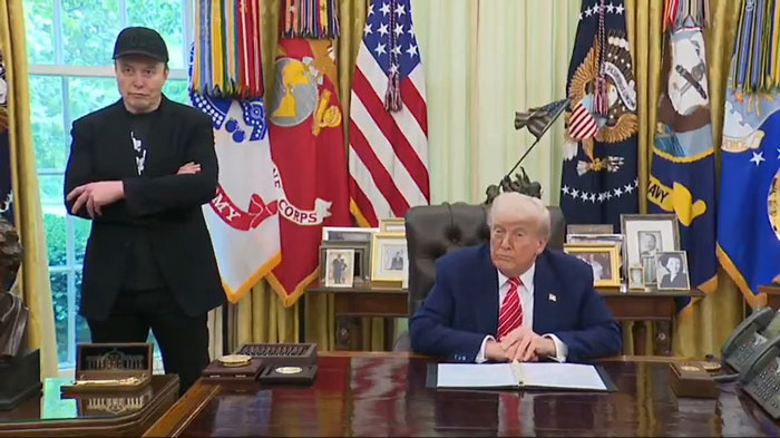 Elon Musk with black eye and head ticks standing near former President Trump in the White House Oval Office. Elon Musk with black eye and head ticks standing near former President Trump in the White House Oval Office.