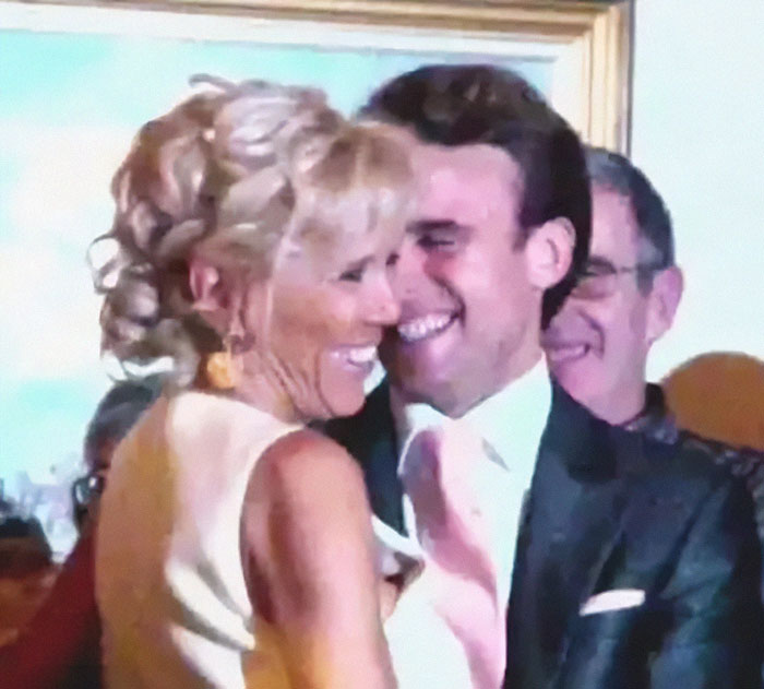 French President Emmanuel Macron and his wife smiling closely at a public event after shoving incident. French President Emmanuel Macron and his wife smiling closely at a public event after shoving incident.