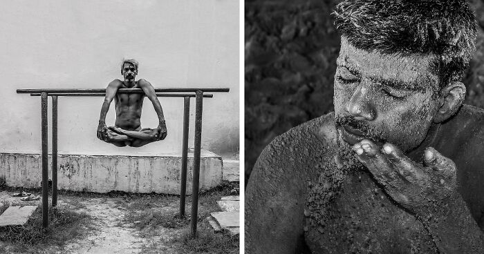 Man practicing Kushti, traditional Indian mud wrestling, shown balancing on a wooden bar and covered in mud in close-up.