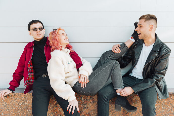 Three friends outdoors showing casual friendship dynamics, illustrating ultimatums and lost friendships from men and women.