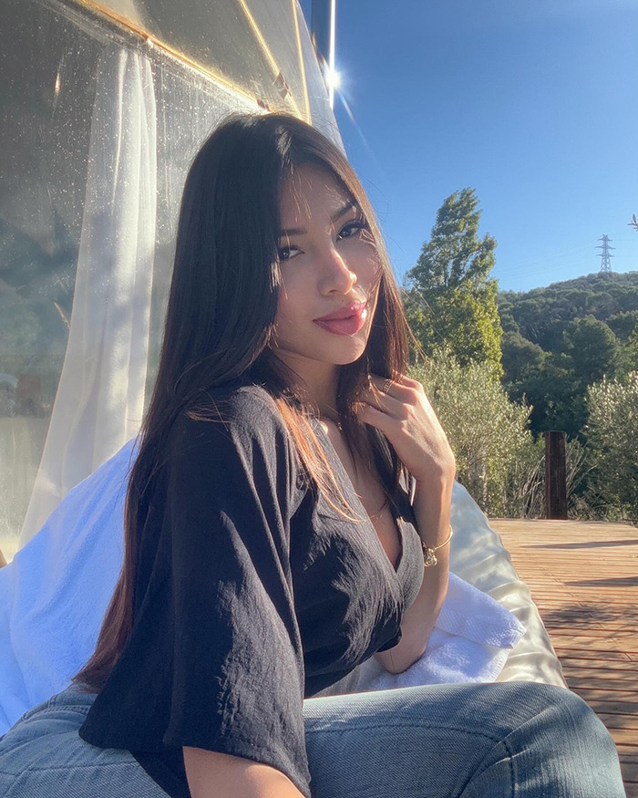 Young woman sitting outdoors on a sunny day, connected to heartbreaking final texts of tourist abducted at vacation hotspot. Young woman sitting outdoors on a sunny day, connected to heartbreaking final texts of tourist abducted at vacation hotspot.