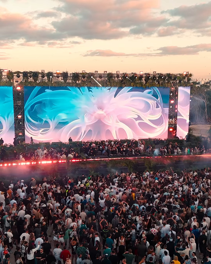 Large crowd at a vacation hotspot event with vibrant light displays, relating to tourist abducted and left in coma. Large crowd at a vacation hotspot event with vibrant light displays, relating to tourist abducted and left in coma.