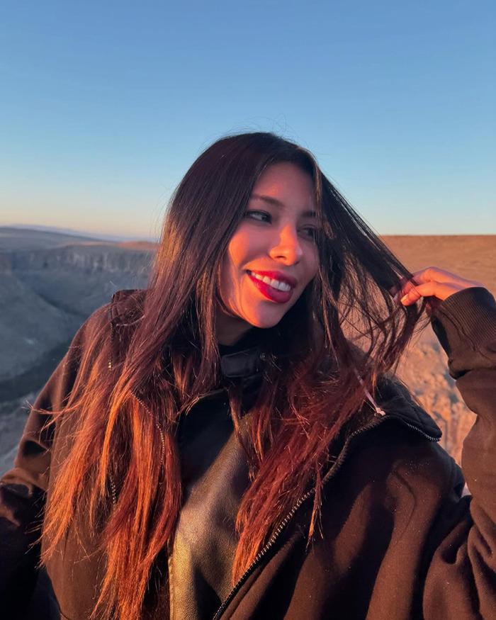 Young tourist smiling outdoors at sunset, relating to heartbreaking final texts of tourist abducted and left in coma. Young tourist smiling outdoors at sunset, relating to heartbreaking final texts of tourist abducted and left in coma.